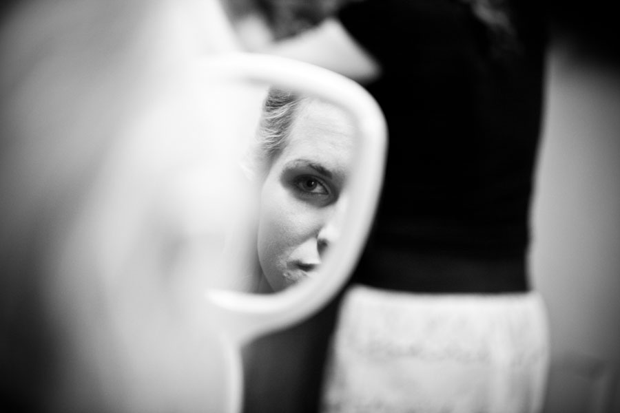 MN Winter Wedding Photography MN Bride looks in mirror for wedding photograph