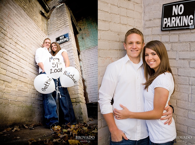 Couple poses with engagement announcement balloons