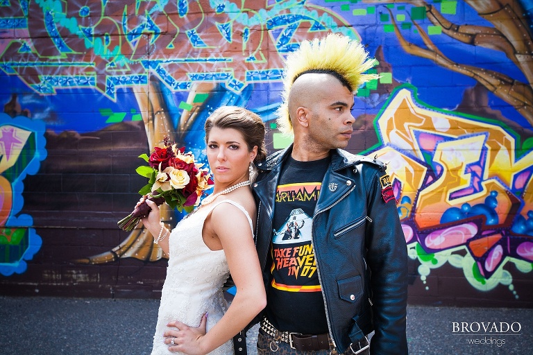 bride poses with a punk man with a mohawk