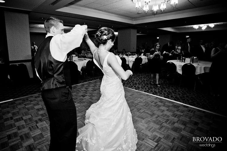 groom twirling bride during first dance
