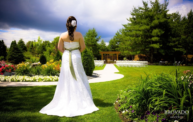 bride stands before her ceremony site