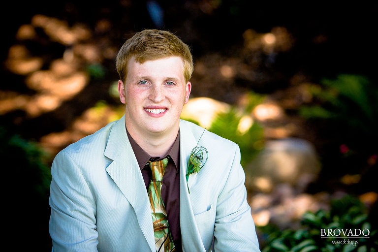 groom poses for a high contrast portrait