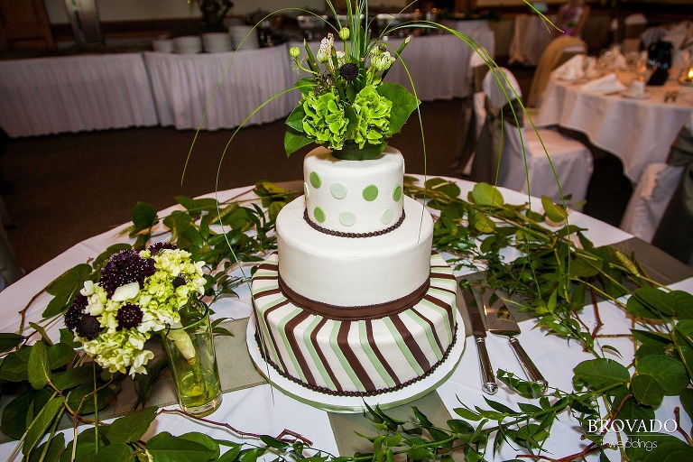 a green cake surrounded by plants