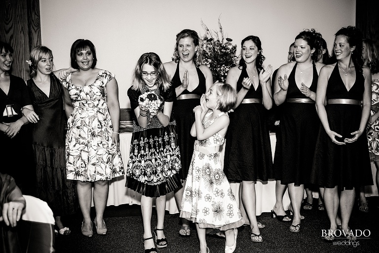 a young girl in shock after catching the bride's bouquet