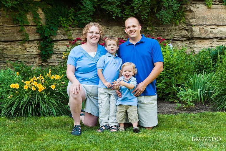 family sitting on green grass