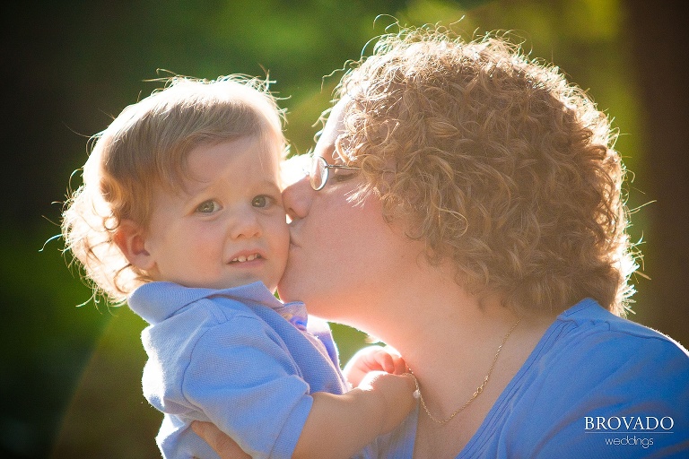 mother kisses her son on the cheek