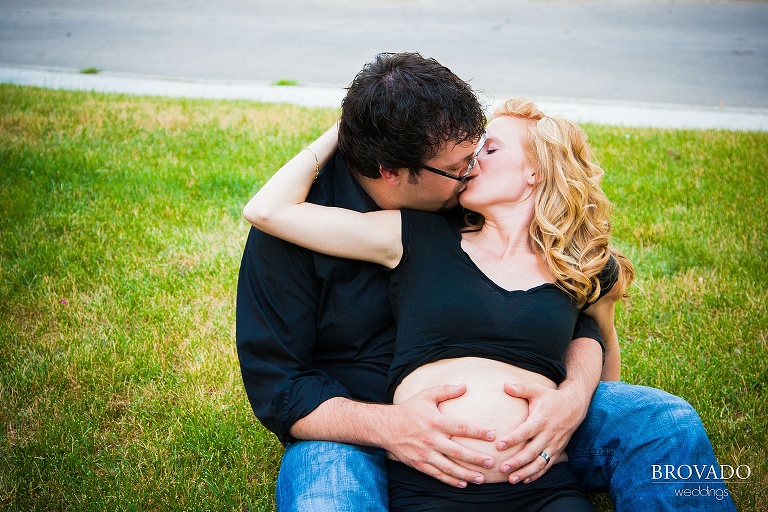 husband holds his wife's pregnant belly