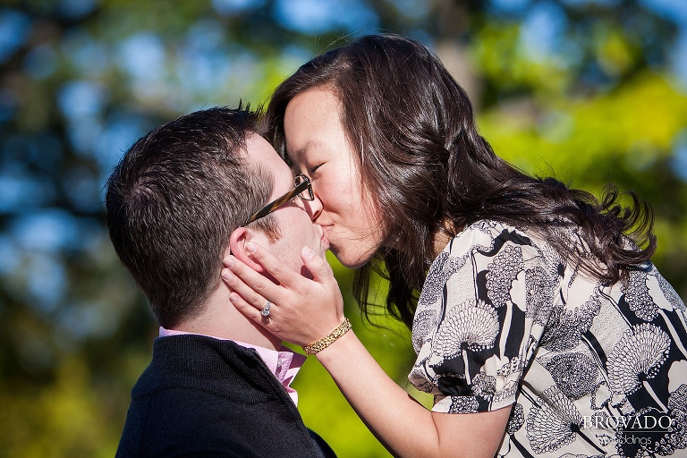 mixed race couple kisses in the sunlight