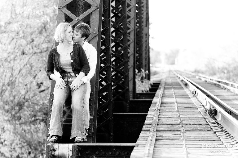 dramatic embrace along railroad tracks