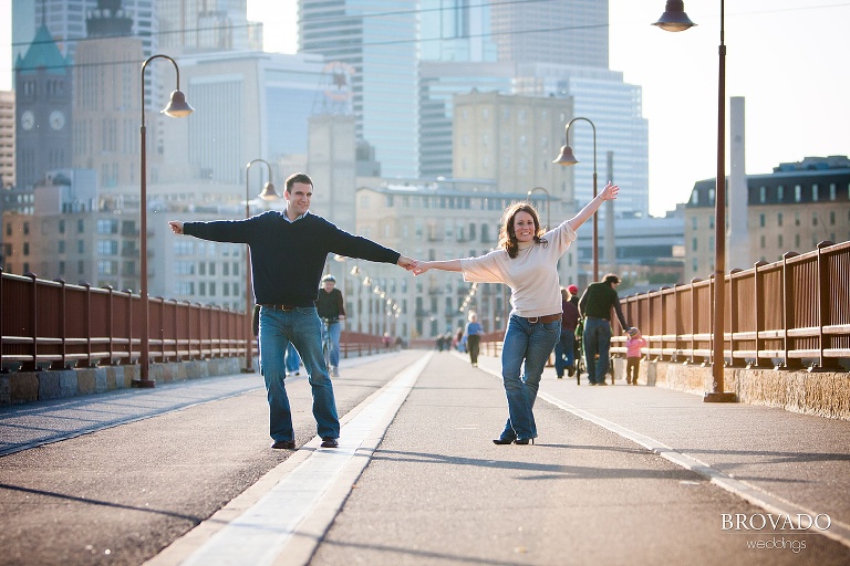 couple pose on stone arch bridge