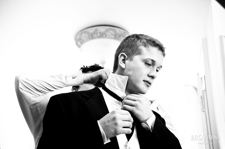 groom getting help with his tie