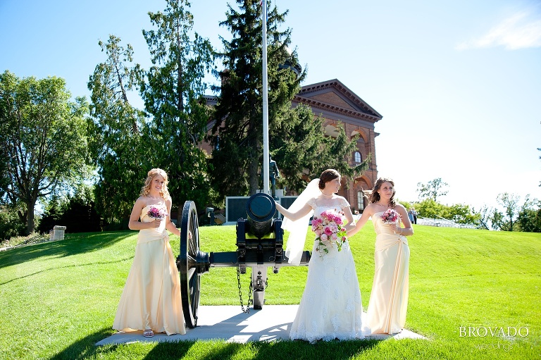 bridesmaids posing next to war monument