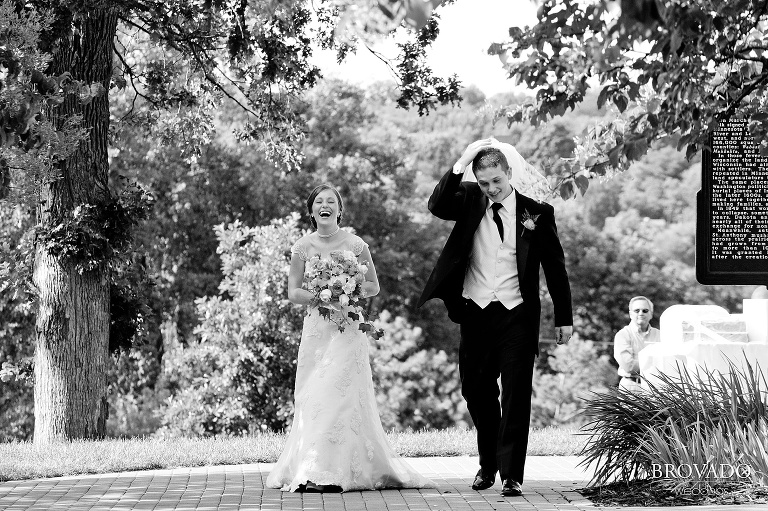 groom jokingly wearing bride's veil