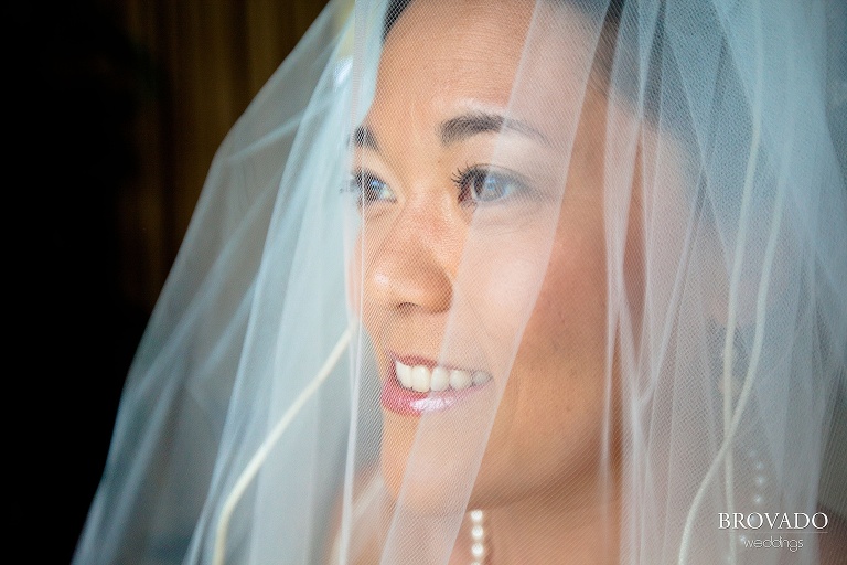 bride smiling through her veil