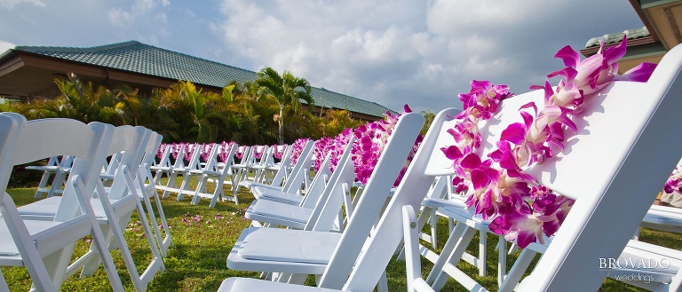 leis wrapped around ceremony chairs