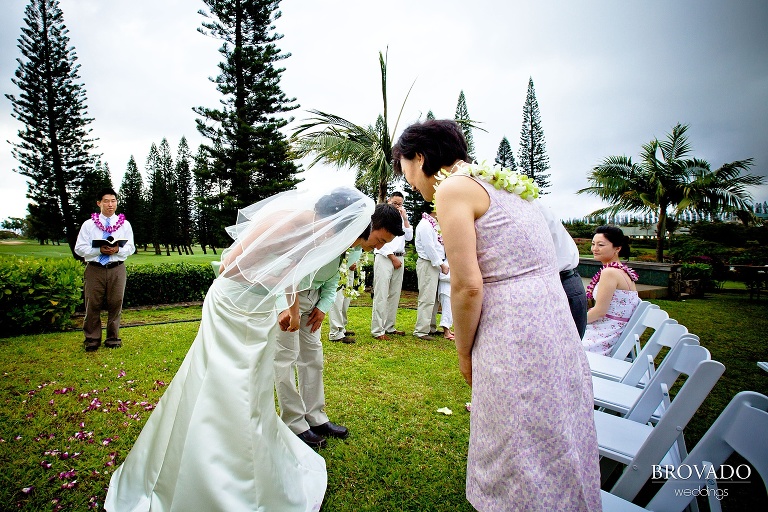 bride and groom bowing to their parents during ceremony