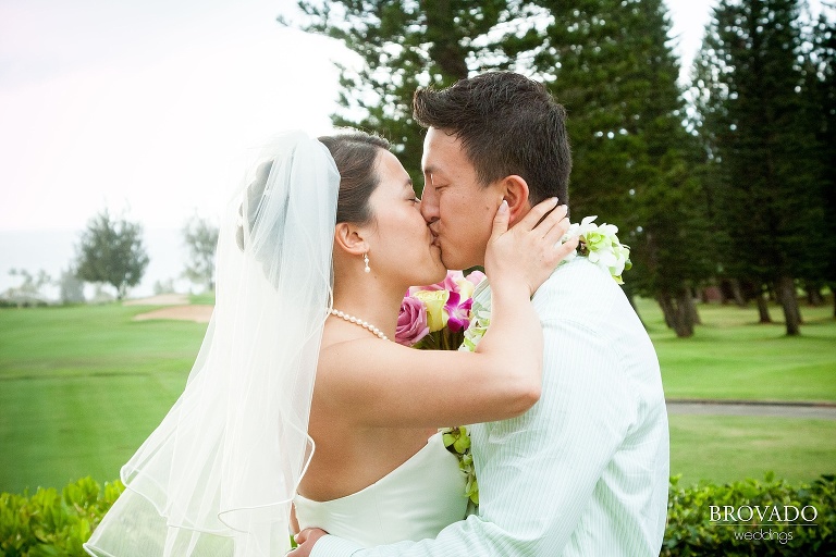 bride and groom share their first kiss