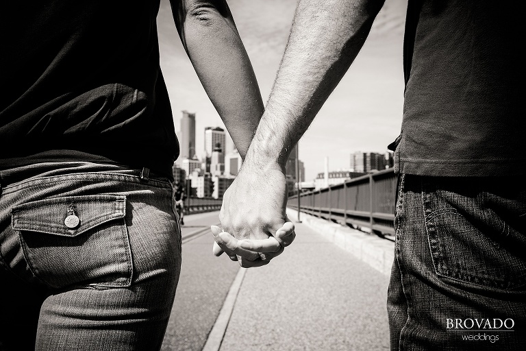 holding hands in front of minneapolis skyline