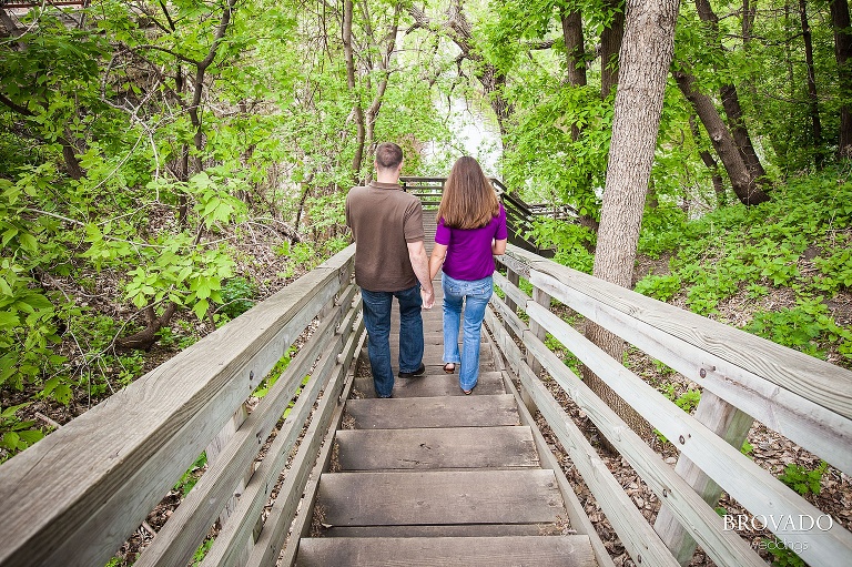 couple walking down wooden staircase