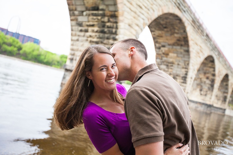 man dips his fiance in front of river