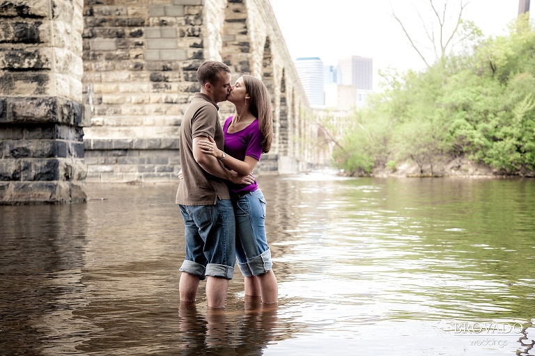 couple standing in mississippi river kissing