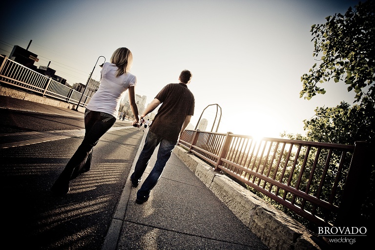 engagement photography of couple walking across the stone arch bridge