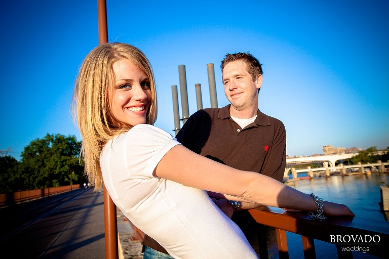 playful engagement photography on stone arch bridge