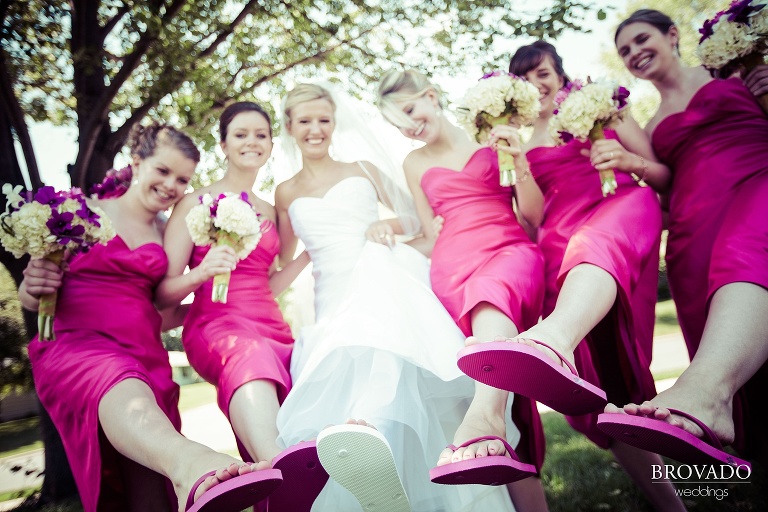 bride and her bridesmaids show off their flip flops