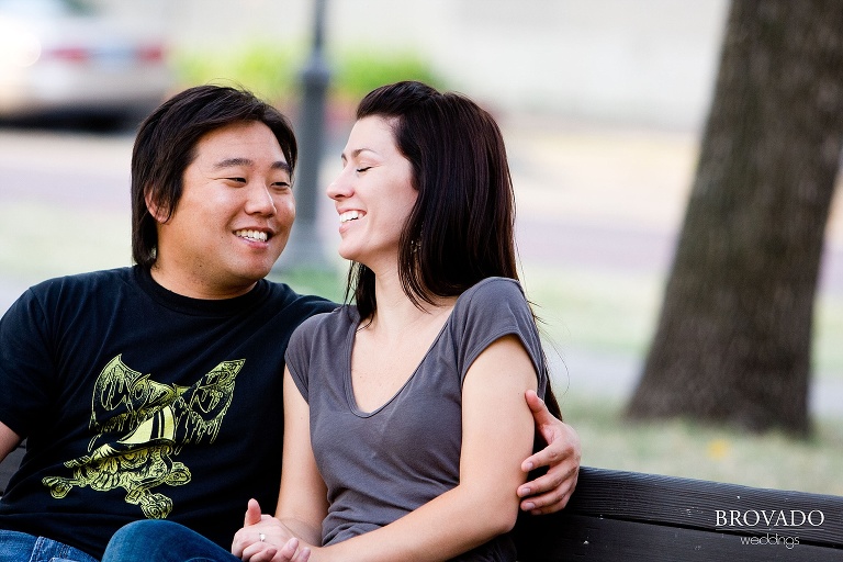 fiances laughing on father hennepin park bench