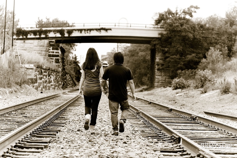 sepia engagement photo on traintracks