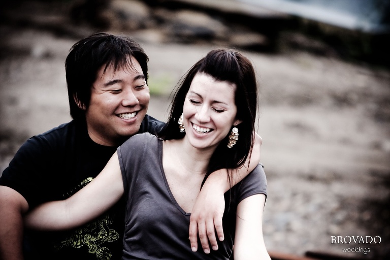 engaged couple laughing in high contrast photograph
