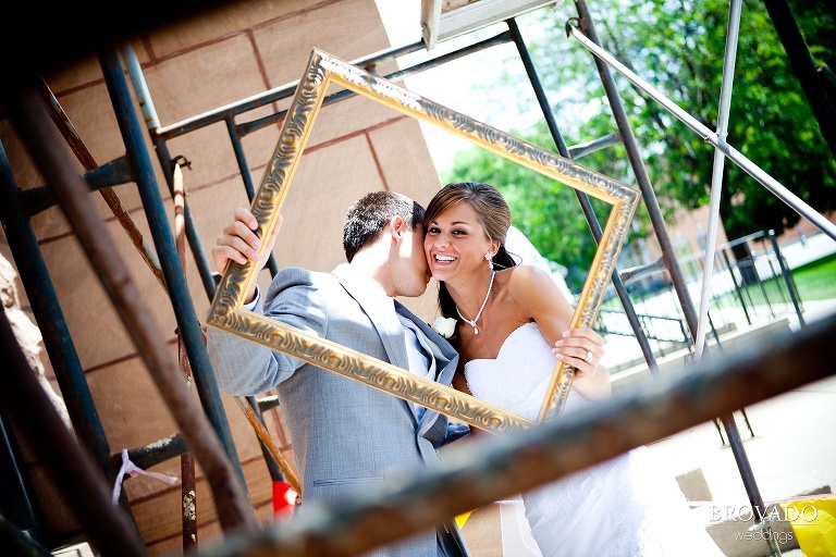 bride and groom posing among scaffolding in iowa