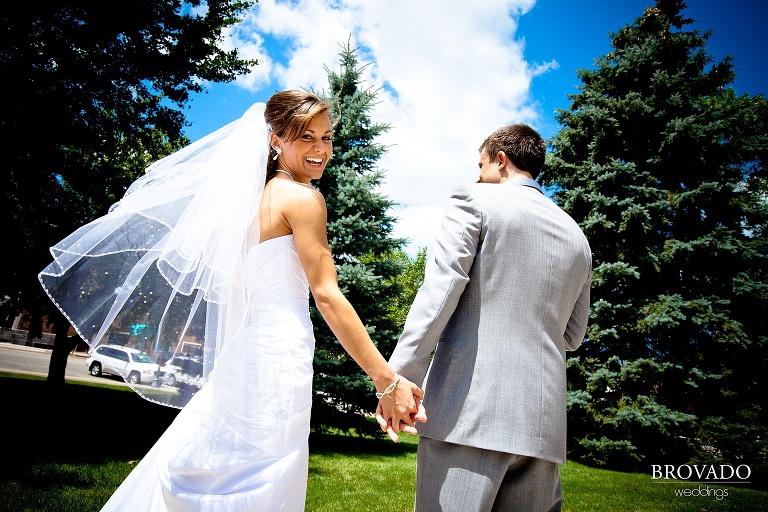 high contrast wedding photograph of bride smiling over her shoulder