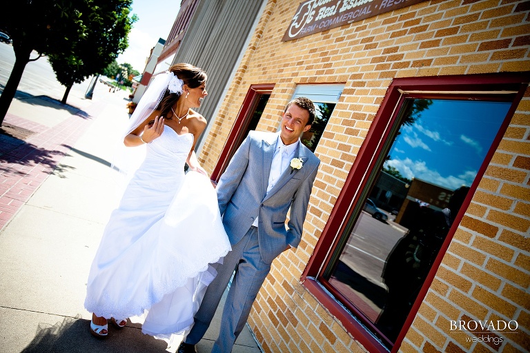 bride and groom walking down main street in iowa