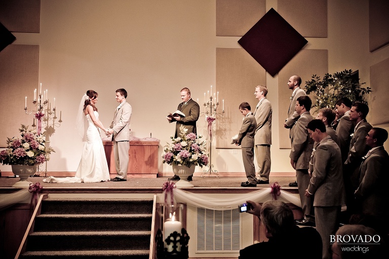bride and groom standing at front of the church during ceremony