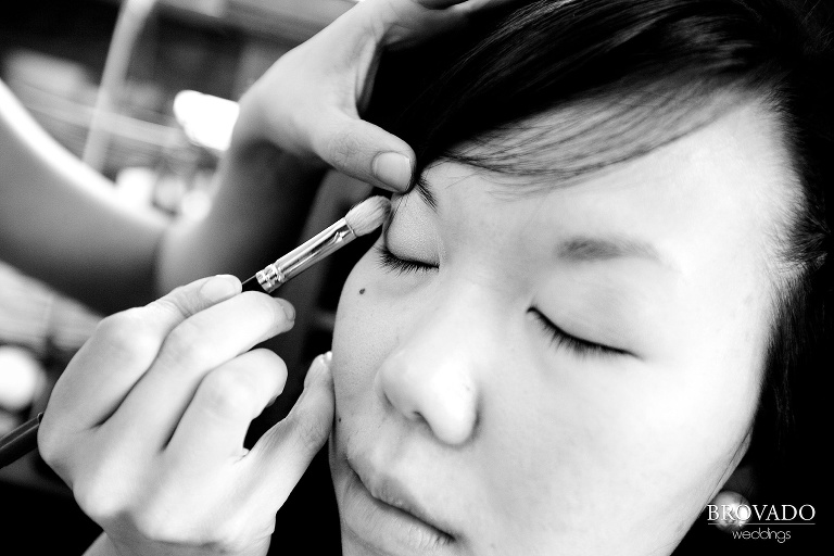 close up black and white photograph of bride getting her makeup done