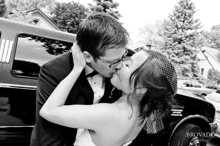 black and white photograph of bride and groom kissing