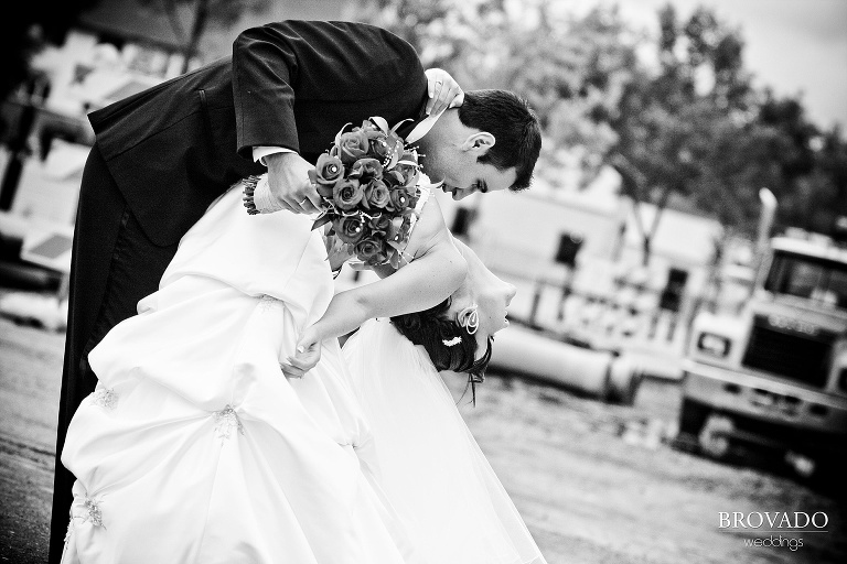 black and white photograph of groom dipping the bride