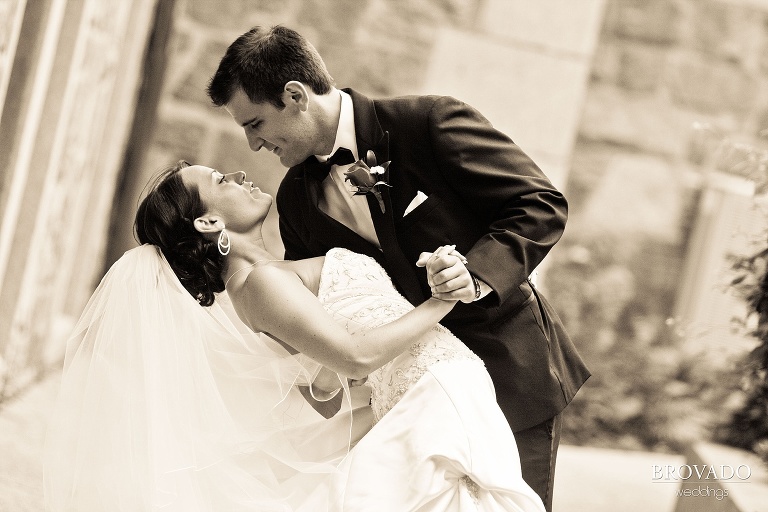 sepia photograph of groom dipping the bride