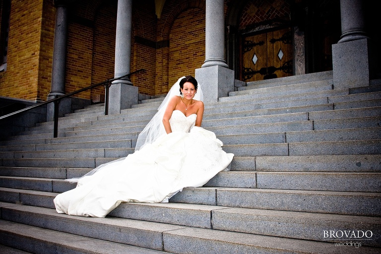 high contrast photograph of bride posing on the front steps of church
