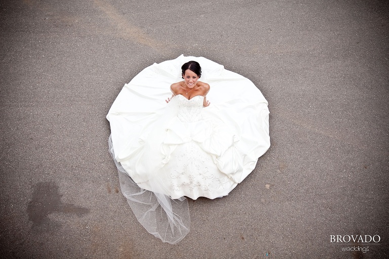 aerial photograph of bride sitting with her wedding dress circled around her