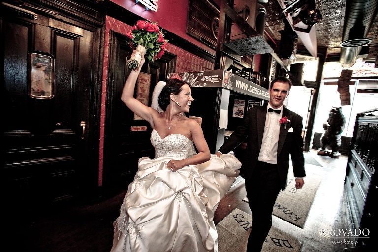 bride and groom cheering and entering their reception site