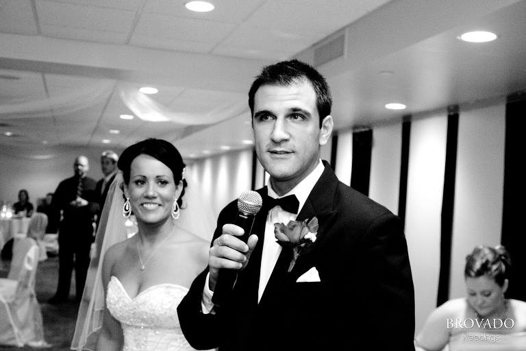 black and white photograph of groom giving speech during wedding reception