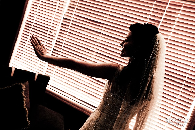 backlit wedding photography of bride admiring her ring