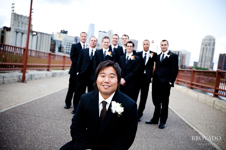 photography of groom crouching in front of his groomsmen