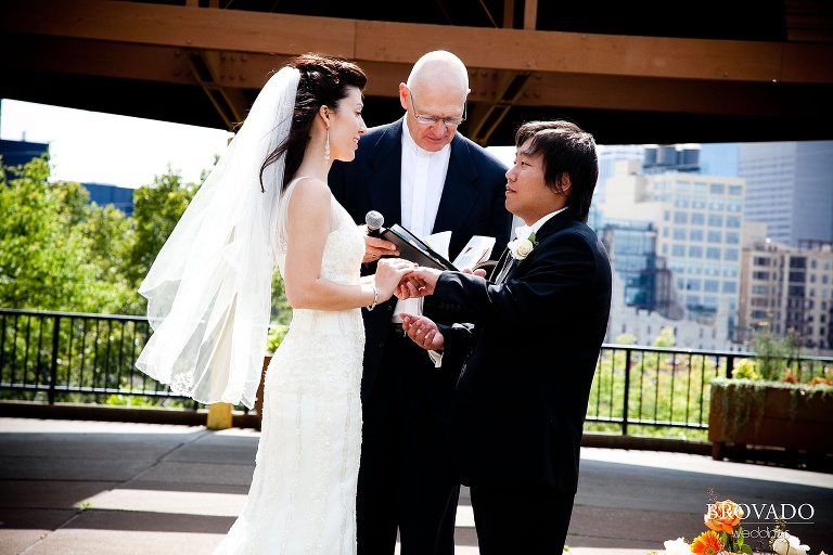 bride and groom exchanging vows in front of minneapolis skyline