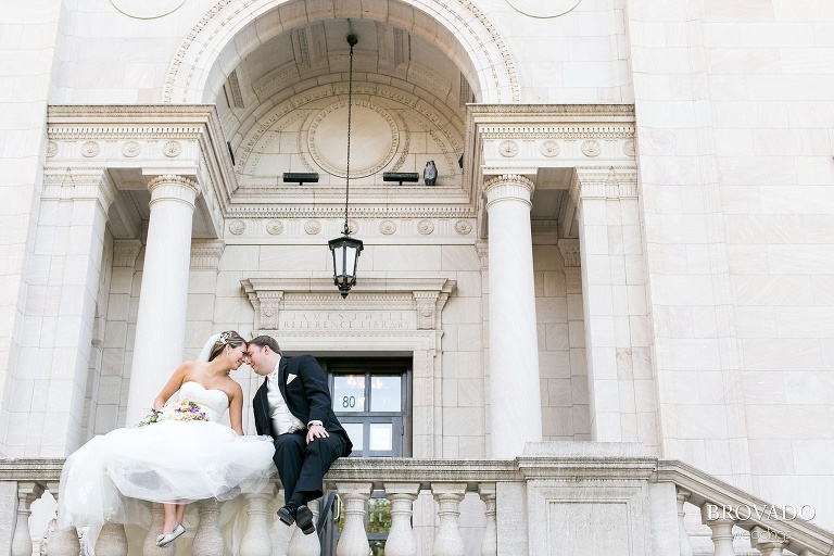Bride and groom share romantic moment in front of historic st paul building