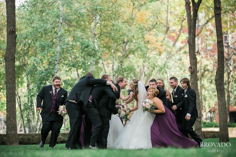 Bride and groom are embraced by their wedding party