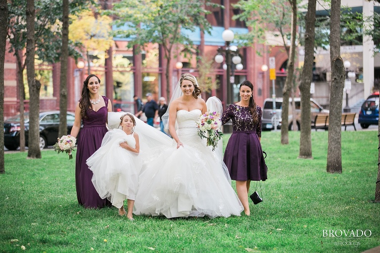 Bride and her bridesmaids walk across the lawn
