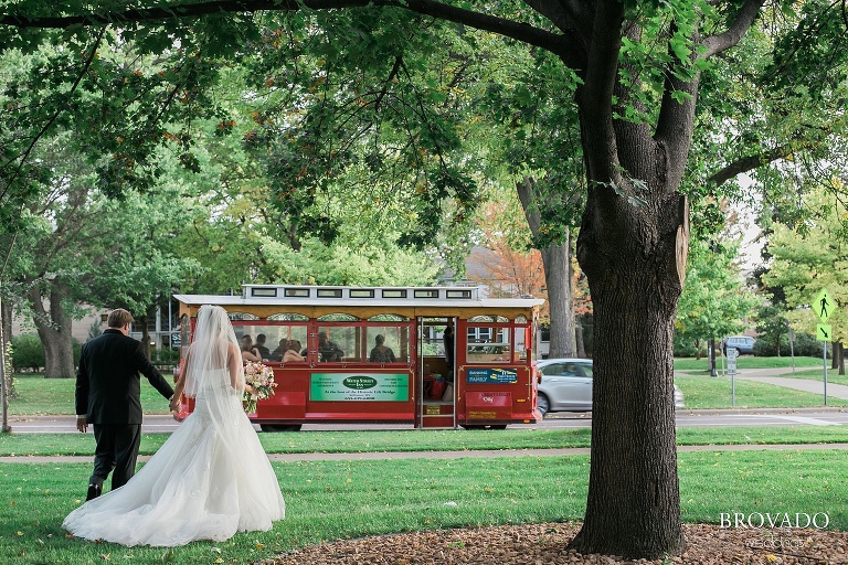 Bride and groom walk to their trolley